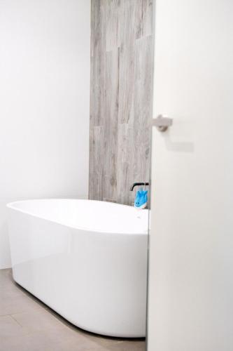 a white bath tub next to a white refrigerator at Kembla in Wollongong