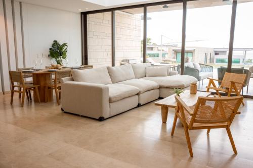a living room with a white couch and a table at Villa Puerta- Luxury Seaside Villa in Pendales