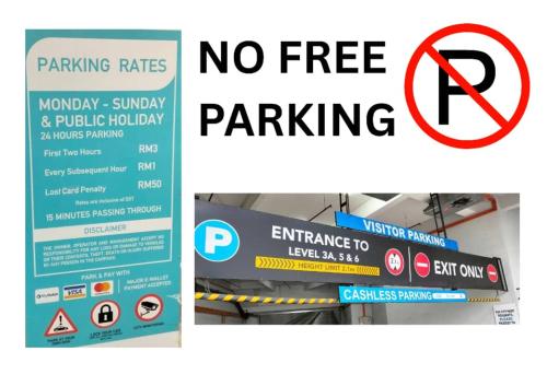 a no free parking sign and a sign that says no parking rates at SEAVIEW LUXURY CONDO HOMESTAY 2Bed 2bath Jesselton Quay by R2 Residence in Kota Kinabalu