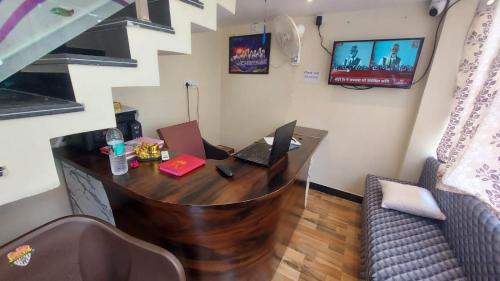 a office with a desk with two laptops on it at Hotel Mahamrityunjay Palace in Ujjain