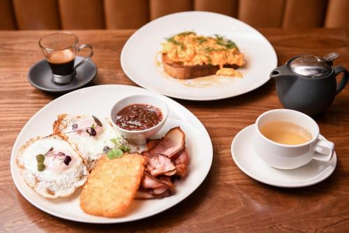 a table with three plates of food and a cup of coffee at Powerhouse Hotel Tamworth by Rydges in Tamworth