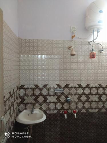 a bathroom with a sink and a toilet in it at Kanykumari Shore River Nest in Taingapatam