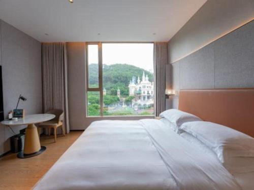 Ένα ή περισσότερα κρεβάτια σε δωμάτιο στο Dongguan Castfast Hotel