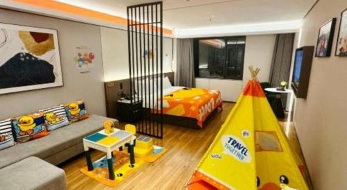 a bedroom with a bed and a play tent in it at Shanshui Trends Hotel-Bantian Dong Branch in Shenzhen