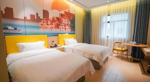 a hotel room with two beds and a table at Quanzhou Binhai Hotel in Quanzhou