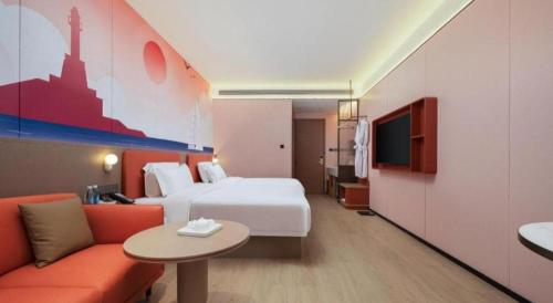 a hotel room with a bed and a couch at Quanzhou Binhai Hotel in Quanzhou