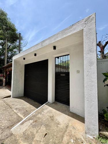 a garage with two sets of garage doors at Coz Haven Ella in Ella