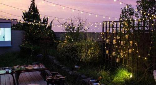 a garden with a string of lights and a fence at Xian Elegant Oriental Hotel in Xi'an