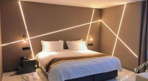 a bedroom with a bed with lights on it at Harbin Splendent Hotel in Harbin