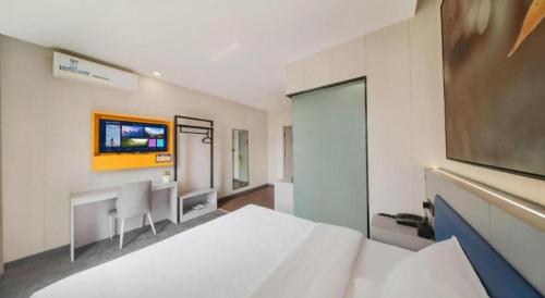 Ένα ή περισσότερα κρεβάτια σε δωμάτιο στο 7 Days Inn Tai'an Dongpingxi Hualian
