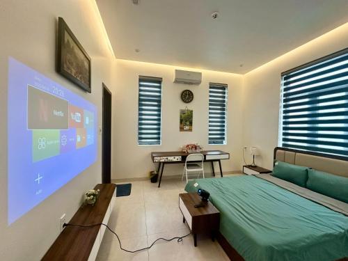a bedroom with a bed and a projection screen at CONIHOUSE - Homestay & Villa in Thôn Lại Thê