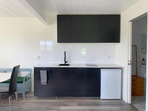 a kitchen with a sink and a counter top at Flähult 107B in Ullared