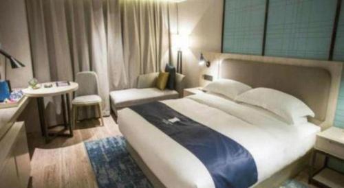 Ένα ή περισσότερα κρεβάτια σε δωμάτιο στο Echarm Hotel Jianshui Gucheng