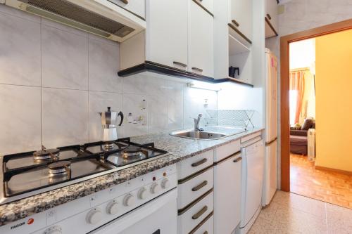 a kitchen with a stove and a sink at Bed&Bcn Sant Andreu in Barcelona