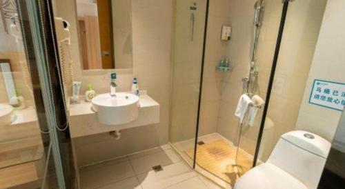 a bathroom with a shower and a sink and a toilet at City Comfort Inn Yingcheng Railway Station Shanghe Square in Xiaogan
