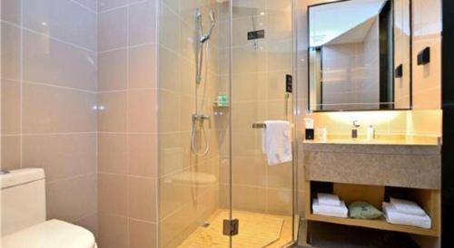 a bathroom with a shower and a toilet and a sink at City Comfort Inn Kunming High Speed Railway South Station Yongxin Harvard in Kunming