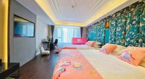 a large bedroom with two beds and a tv at James Joyce Coffetel Harbin West High-speed Railway Station Wanda Plaza in Harbin