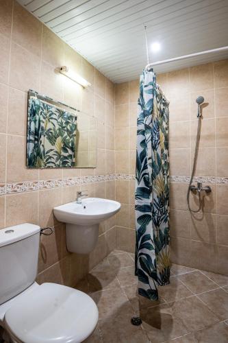 a bathroom with a toilet and a sink at Lotos Hotel in Balchik