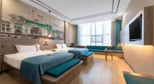 a hotel room with two beds and a flat screen tv at Han Hotel Meisu Xi'an Longshouyuan Shenglong Plaza in Xi'an