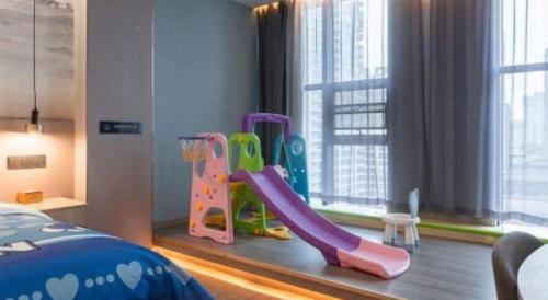 a childs bedroom with a slide and a play set at Han Hotel Meisu Xi'an Longshouyuan Shenglong Plaza in Xi'an