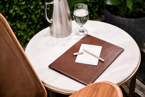 a table with a napkin and a glass of wine at Powerhouse Hotel Tamworth by Rydges in Tamworth