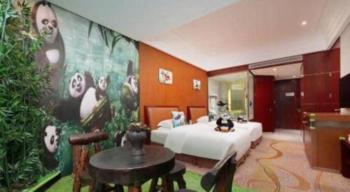 a hotel room with a bed and a table in it at Balan International Hotel in Dujiangyan