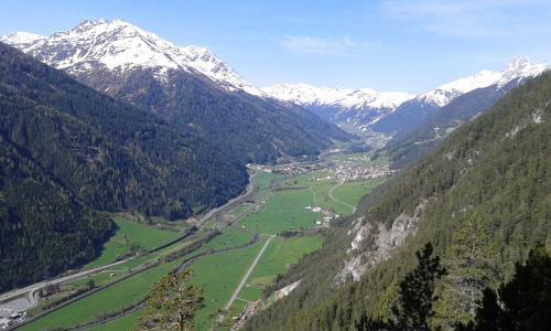 a view of a valley with snow capped mountains at Appartements Tyrol in Pettneu am Arlberg