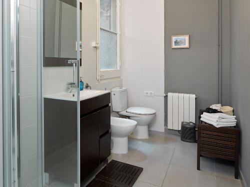a bathroom with a toilet and a sink and a shower at Bruc & Bruc in Barcelona