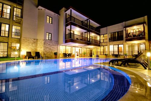 a large swimming pool in front of a building at night at Venus Suite Hotel in Pamukkale