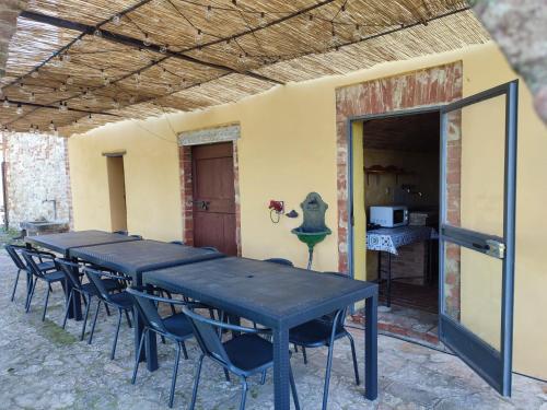 a group of tables and chairs in a room at Podere Rinascidentro in Asciano