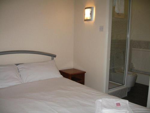 A bed or beds in a room at The Barrington Hotel 