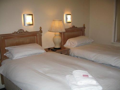 A bed or beds in a room at The Barrington Hotel 