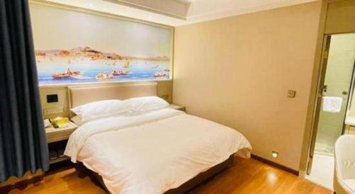 a bedroom with a bed and a painting on the wall at Vienna Hotel Beijing Changping Metro Station in Beijing