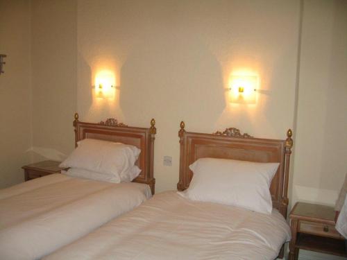 A bed or beds in a room at The Barrington Hotel 