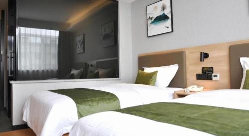 Ένα ή περισσότερα κρεβάτια σε δωμάτιο στο Green Tree Inn Anhui Tianchang Economic Development Zone