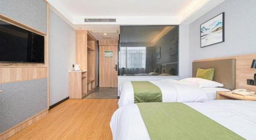 Ένα ή περισσότερα κρεβάτια σε δωμάτιο στο Green Tree Inn Anhui Tianchang Economic Development Zone