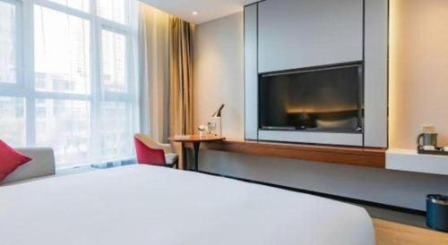 Ένα ή περισσότερα κρεβάτια σε δωμάτιο στο Borrman Hotel Xi'an North High-speed Railway Station
