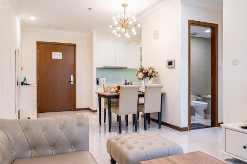 a kitchen and dining room with a table and chairs at Landmark Plus Vinhomes CityView Suite in Ho Chi Minh City