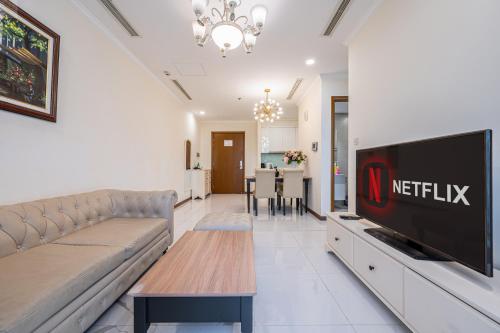a living room with a couch and a tv at Landmark Plus Vinhomes CityView Suite in Ho Chi Minh City