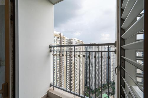 a balcony with a view of a tall building at Landmark Plus Vinhomes CityView Suite in Ho Chi Minh City