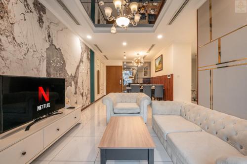 a living room with a couch and a tv at Landmark Plus Vinhomes CityView Suite in Ho Chi Minh City