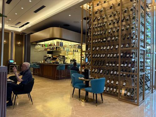 a man sitting at a bar in a wine store at STAR KLCC By Comfort Hospitality in Kuala Lumpur