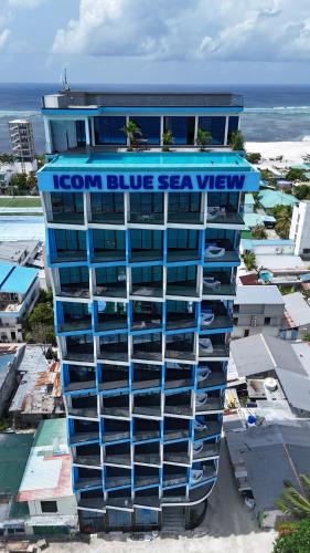 a building with a blue seaview sign on it at iCom Blue Seaview in Maafushi
