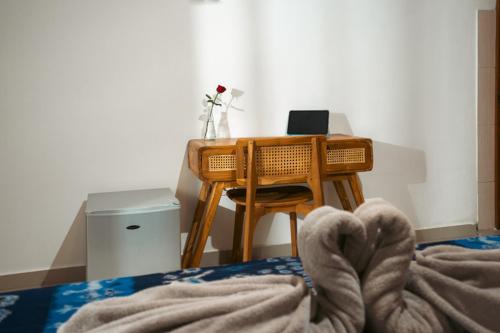 a desk with a laptop computer on top of it at Zena Surf Suite in Uluwatu