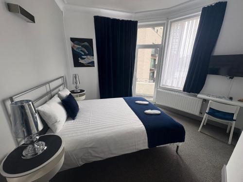 a hotel room with a bed and a window at Eurotel in Liège