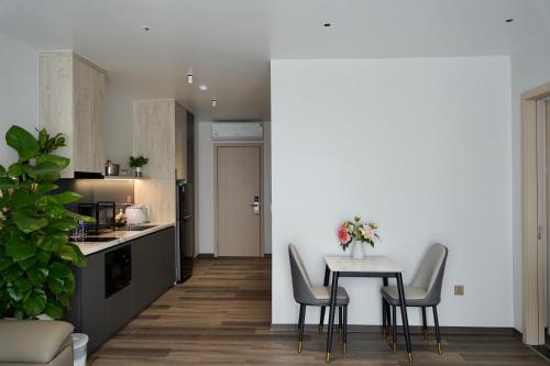 Ðông KhêにあるMiami Luxury Apartment Hai Phongの部屋にテーブルと椅子のあるキッチン