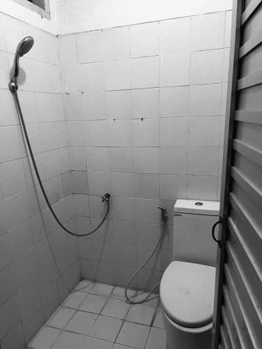 a bathroom with a shower with a toilet at Kiwi Globe BnB in Senggigi 