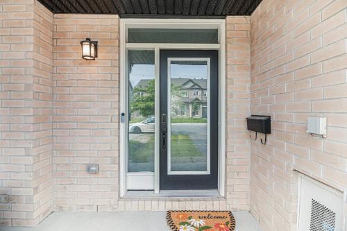 a glass door on a brick house with at Luxurious Tastefully Furnished 3 bedroom Home in Ottawa in Ottawa