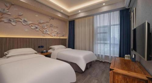 Télévision ou salle de divertissement dans l'établissement Xi'an Huiya Tianmu Hotel