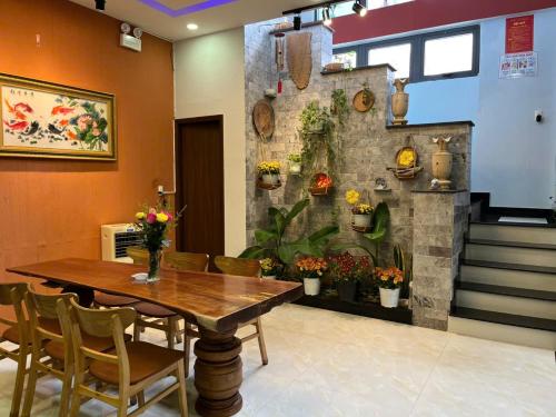 a dining room with a wooden table and chairs at Leila House - DaNang Central - 3BRs - Free Airport Shuttle in Da Nang